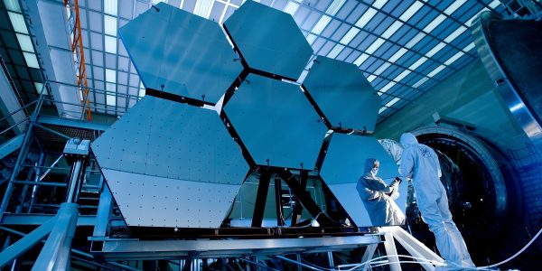 Researcher in front of hexagonal solar panels 